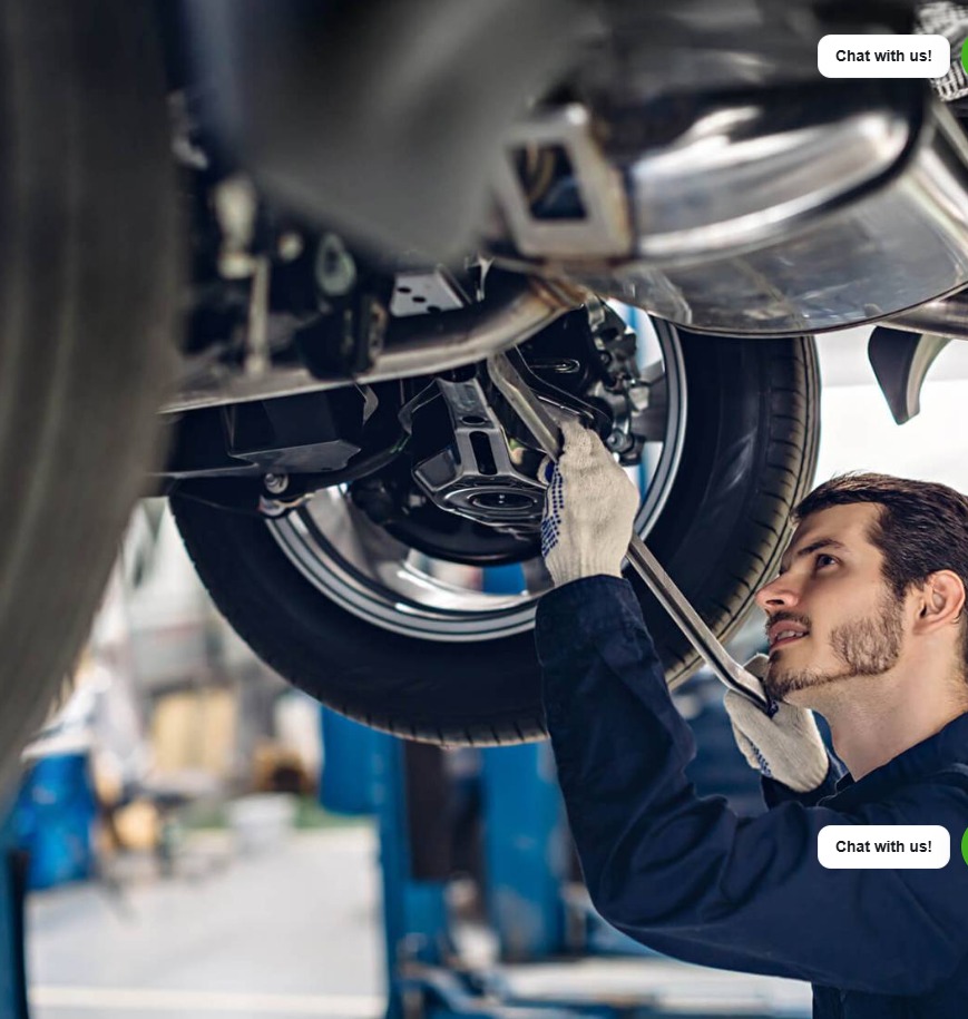 Technician inspecting a vehicle on a workshop lift