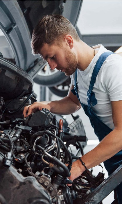 Mechanic carefully inspecting an engine
