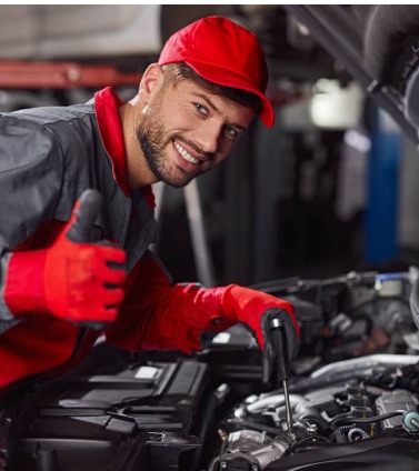 Automotive specialist in a red cap